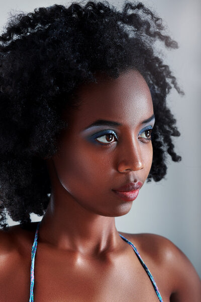 Beautiful african young woman looking outside the picture.