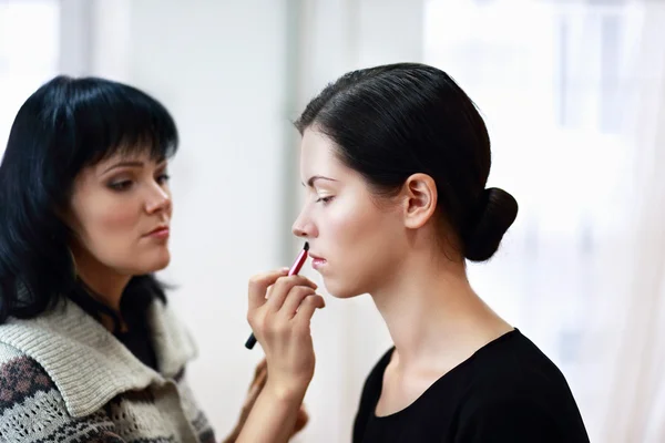 Donna che applica il make-up da make-up artist — Foto Stock