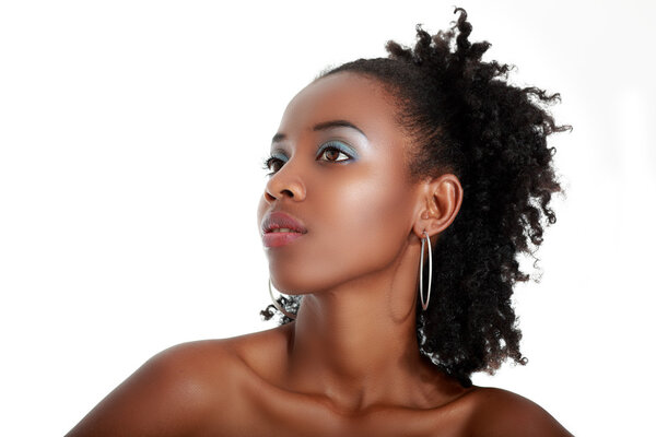 Beautiful young african american model posing against a white background