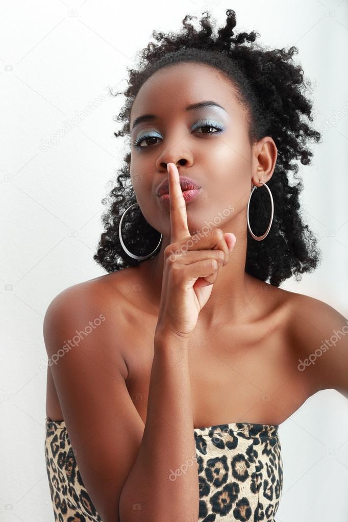 African American woman making  hushing gesture