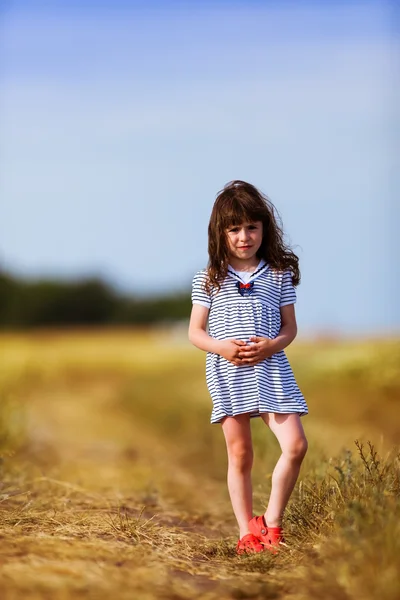 Little girl in a black white striped dress — Stock Photo, Image