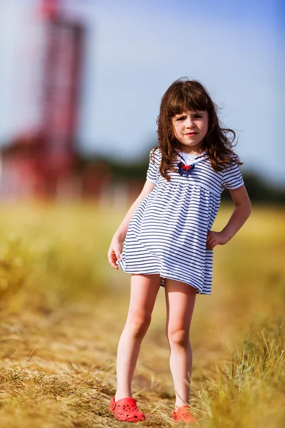 Little girl in a black white striped dress — Stock Photo, Image