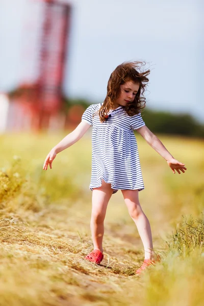 Little girl in a black white striped dress — Stock Photo, Image