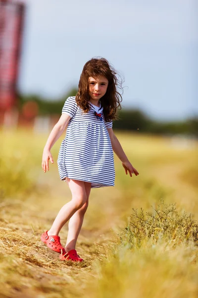 Little girl in a black white striped dress — Stock Photo, Image