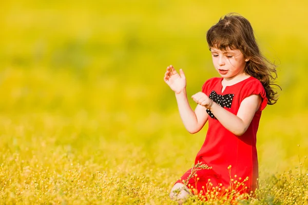 Little girl in a red dress — Stock Photo, Image