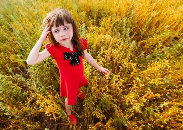 Little girl in a red dress — Stock Photo, Image