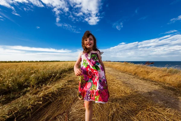 Girl in a colorful dress — Stock Photo, Image