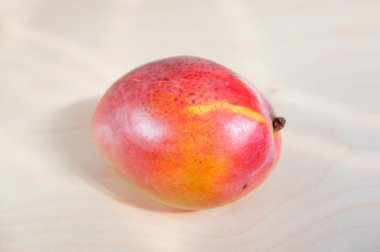Kırmızı olgun mango closeup ahşap yüzey üzerinde.