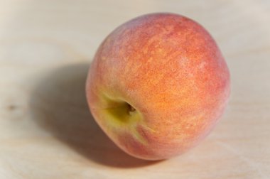 Juicy ripe peach with Golden sideways on wooden