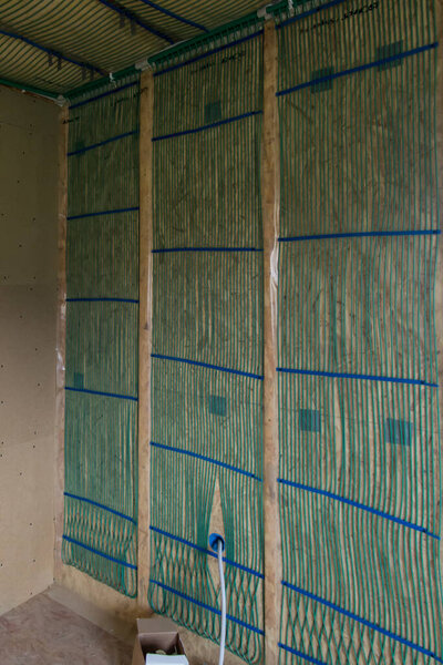 Capillary heating in the house with frame technology. Capillary mats on MDF boards prepared to be covered with plasterboards.