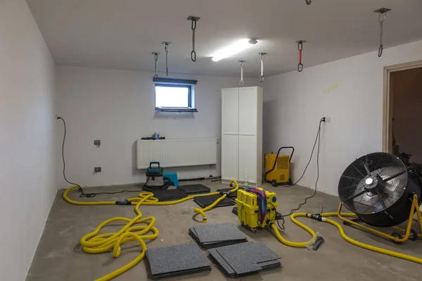 Drying a concrete floor under a fabric covering. After pouring, initial drying, and then drilling and blowing hot air into the heating zone and drying the outgoing air.