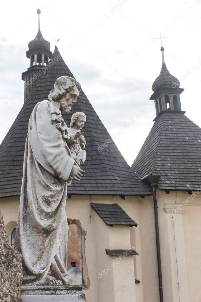 The old statue of St. Joseph with Jesus in his arms at the church in Sadow near Lubliniec in Silesia, Poland