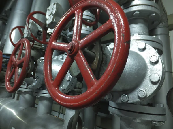 Pipes and valves with red knobs — Stock Photo, Image