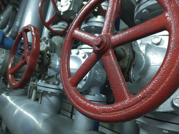 Pipes and valves with red knobs — Stock Photo, Image