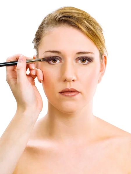 Applying makeup on beautiful model Royalty Free Stock Images