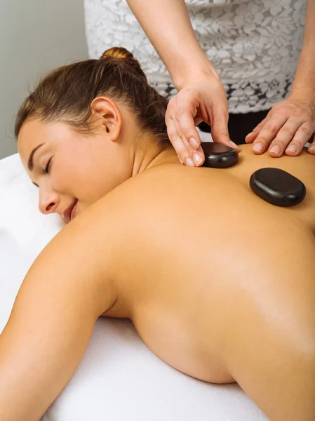 Placing hot stones during massage — Stock Photo, Image