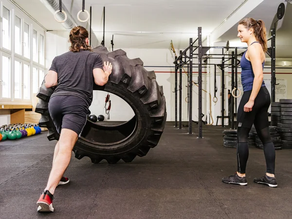 Paar trainiert mit Reifen in Crossfit-Fitnessstudio — Stockfoto