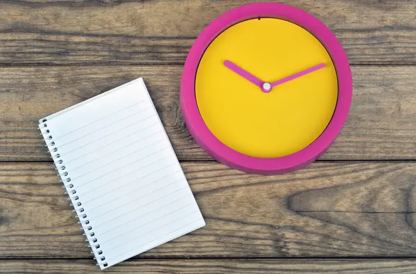 Clock on wooden table — Stock Photo, Image