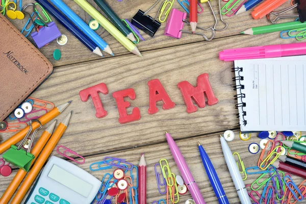 Team word and office tools on wooden table — Stock Photo, Image