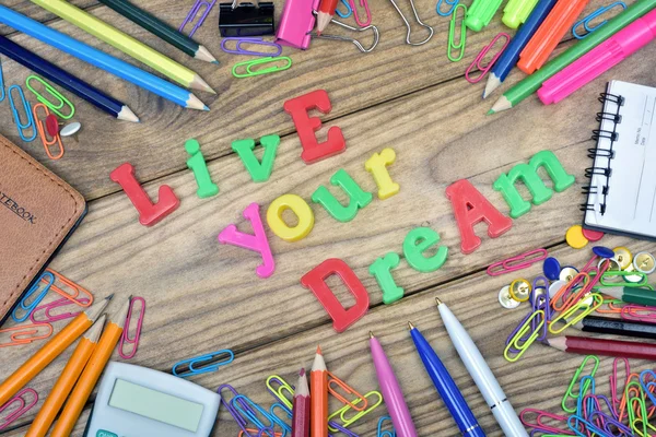 Live your dream text on wooden table