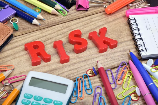 Risk word and office tools on wooden table — Stock Photo, Image