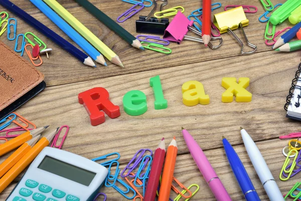 Relax word and office tools on wooden table — Stock Photo, Image