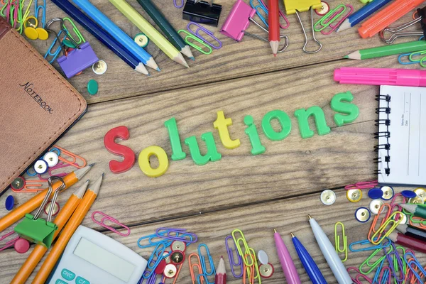 Solutions word and office tools on wooden table — Stock Photo, Image