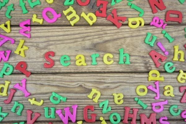 Search on wooden table — Stock Photo, Image