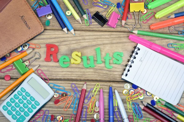 Results word and office tools on wooden table — Stock Photo, Image