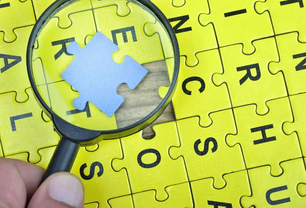 Puzzle on wooden table — Stock Photo, Image