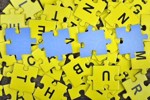 Puzzle on wooden table — Stock Photo, Image