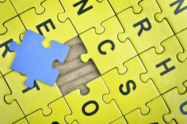 Puzzle on wooden table — Stock Photo, Image