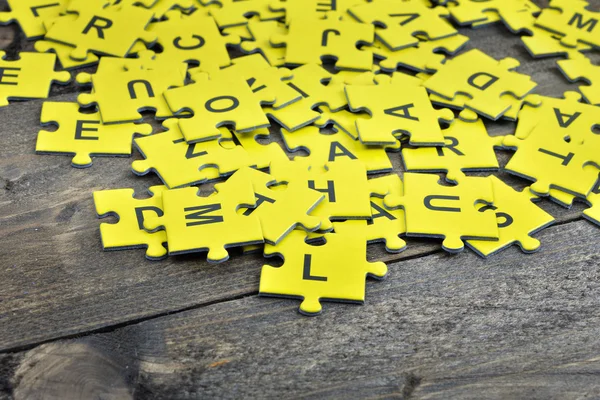 Puzzle on wooden table — Stock Photo, Image