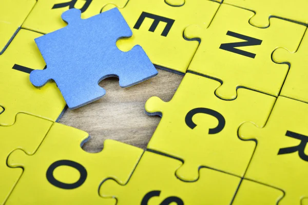 Puzzle on wooden table — Stock Photo, Image