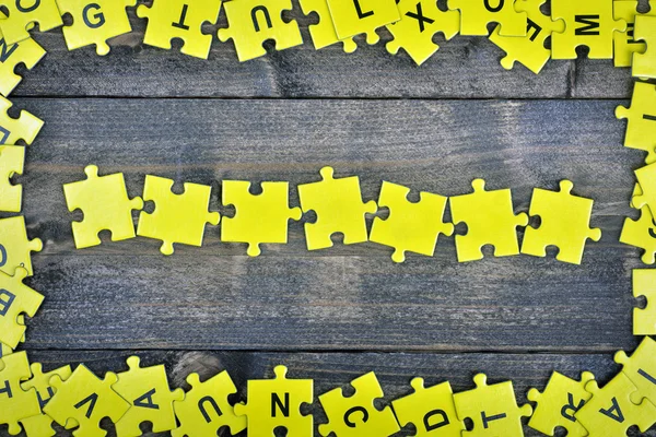 Puzzle on wooden table — Stock Photo, Image