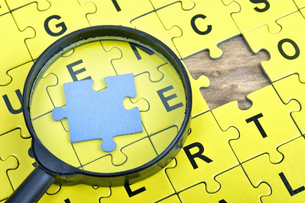 Puzzle on wooden table — Stock Photo, Image