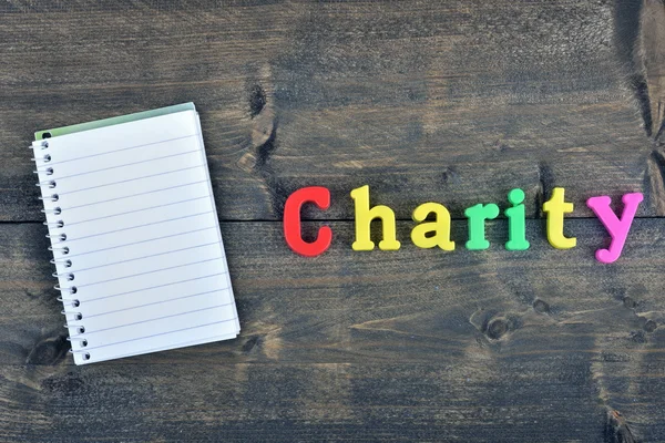 Charity on wooden table — Stock Photo, Image