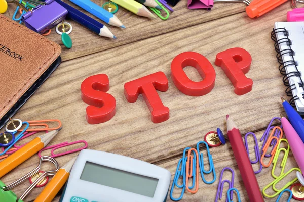 Stop palabra y herramientas de oficina en la mesa de madera —  Fotos de Stock