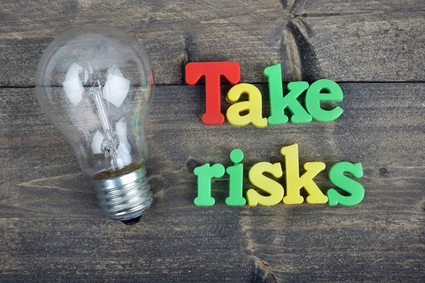 Take risks on wooden table — Stock Photo, Image