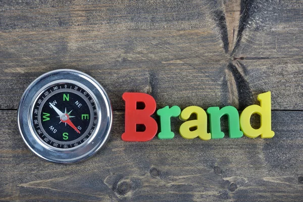 Brand on wooden table — Stock Photo, Image