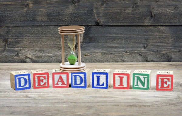 Hourglass and word deadline — Stock Photo, Image