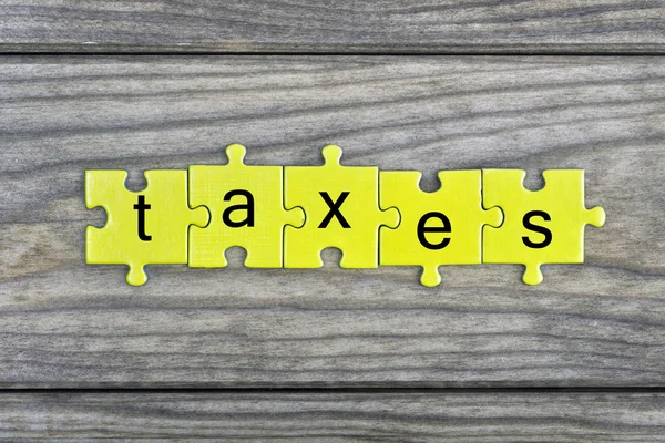 Puzzle com palavra Impostos — Fotografia de Stock