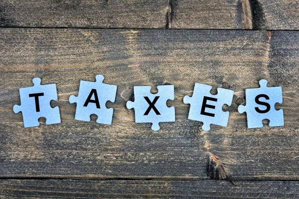 Puzzle com palavra Impostos — Fotografia de Stock