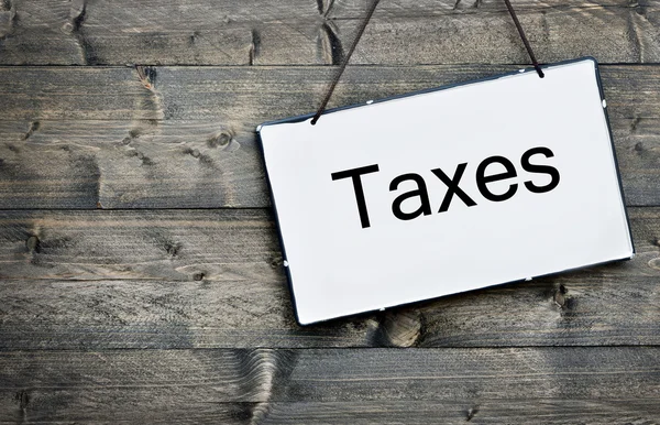 Taxes on wooden table — Stock Photo, Image