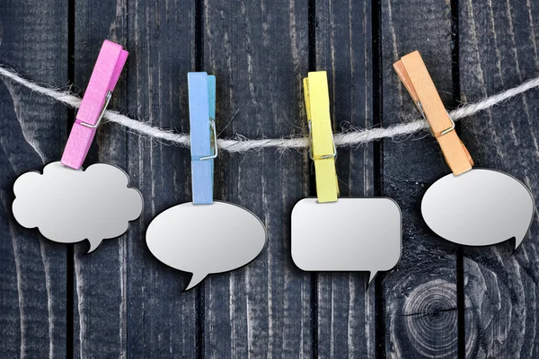 Chat bubbles hanging on clips — Stock Photo, Image