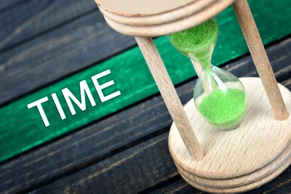 Time text and hourglass on table — Stock Photo, Image