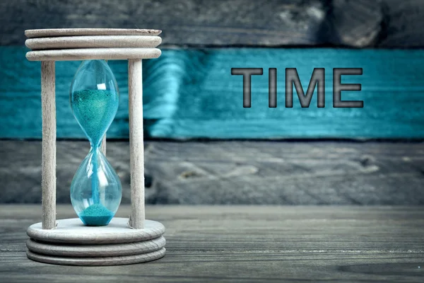 Time text and hourglass on table — Stock Photo, Image