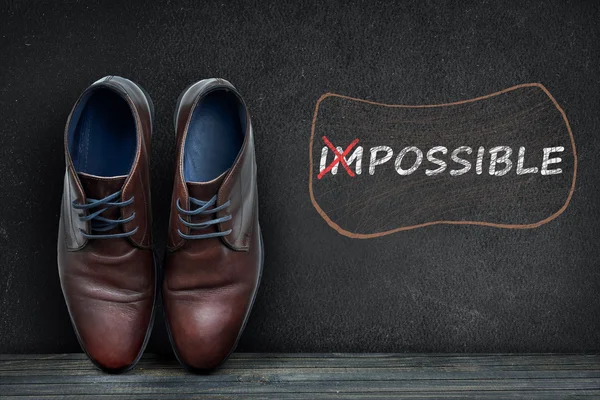 Possible text on black board and business shoes — Stock Photo, Image