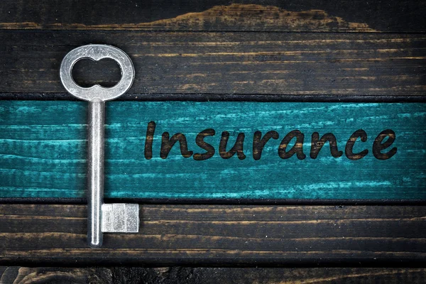 Insurance word and old key — Stock Photo, Image