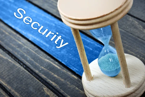 Security text and hourglass on table — Stock Photo, Image